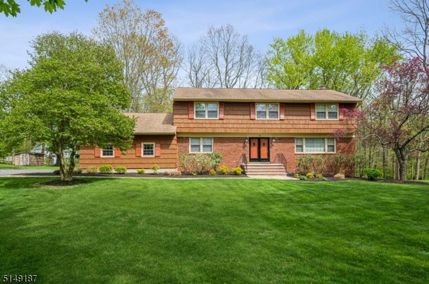 Picturesque, private retreat!  Spacious and spotless Colonial with 5 bedrooms and 2 1/2 bathrooms is set on more than half an acre of manicured property on a desirably tranquil cul-de-sac in Morristown. Not far from an historic downtown bustling with shops, restaurants, and activities, and just a ten-minute drive to the train station, this home offers a peacefully situated haven in this sought-after community.  A large foyer and warm hardwood floors greet you as you enter inside to the sunny living room and formal dining room with elegant crown molding and a chair rail. The large, bright kitchen is equipped with ample cabinet and counter space, a center island, and a cozy breakfast nook.  Throw open the sliding glass doors and step out onto the huge deck spanning the length of the house and overlooking the deep back yard and woods beyond " the perfect setting for summertime entertaining. A spacious family room includes a wood-burning fireplace and another set of sliding glass doors to access the deck. A bedroom, powder room, convenient laundry room, and access to the attached two-car garage complete the first floor.  On the second floor is the spacious primary bedroom suite complete with a walk-in closet and a full en suite bathroom, along with three additional bedrooms and a full hallway bathroom.   The basement level offers loads of storage and vast possibilities.