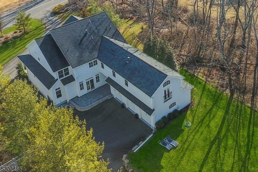 Sophistication and expert craftsmanship at every turn in this stunning one-of-a-kind custom Colonial built in 2011 with approximately 6627 square feet of living space including the lower level with 7 Bedrooms, 5 Full and 1 Half Baths situated on .76 acres of level park-like property. Loaded with on-trend updates and all the bells and whistles including high ceilings, open floor plan, 1st floor Guest Suite, Gourmet Chef's Kitchen, Mudroom and oversized 3-car attached garage. Enter through front porch and impressive Foyer to Living and Dining Room flowing directly to the Butler's pantry then the Eat-In Chef's Kitchen features Viking Professional stainless steel appliances, granite counters, large center island with seating for 4, breakfast area and access to Mudroom, Laundry Room, 3-car Garage and patio. Exquisite Family Room with statement stone gas fireplace opens to Kitchen and paver patio. 1st Floor Bedroom Suite with Full Bath. Updated Powder Room completes 1st floor.  2nd level features dazzling Primary Bedroom Wing with Sitting Room, Bedroom with vaulted ceiling, fireplace, walk-in closet, separate Office with Juliet balcony and Luxurious Primary spa-like Bathroom. 4 additional Bedrooms on 2nd level are sun-drenched with great closets and share two additional Full Baths. Massive Lower Level with high ceilings features a Guest Bedroom, Full Bath, Rec Room, Game Room, Media Area and storage areas. Stellar outdoor private setting with patios and plenty of green space.