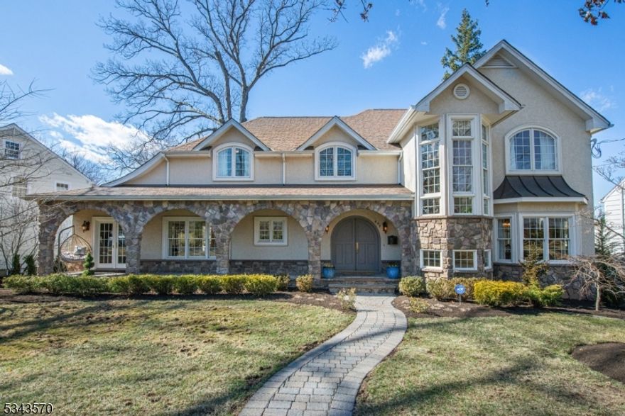 Nestled in the prestigious Wychwood section, this one-of-a-kind custom home features exquisite stone arches that create a picturesque covered porch, seamlessly framing the custom arched front door. A striking two-story staircase tower with oversized windows floods the home with natural light, enhancing its timeless elegance.Inside, the thoughtfully designed floor plan offers both grand entertaining spaces and intimate retreats. The gourmet eat-in kitchen boasts high-end appliances, a walk-in pantry, and a breakfast room that flows into the sunken family room with soaring ceilings, a wall of windows, and a double-sided stone fireplace. A formal dining room, a sophisticated living room, and a private office with French doors complete the main level.Upstairs, the luxurious primary suite features a private balcony, a spa-like ensuite bath with a soaking tub, a walk-in shower, and a custom closet system. Three additional spacious bedrooms, including a second en-suite, and a convenient second-floor laundry complete the level.The finished lower level offers a recreation room, full bath, and direct access to the oversized three-car garage. A private driveway from Oak Ave leads to the gated, fully fenced backyard with a deck, paver patio, and lush landscaping. This extraordinary home is truly a rare find in one of Westfield's most sought-after neighborhoods.