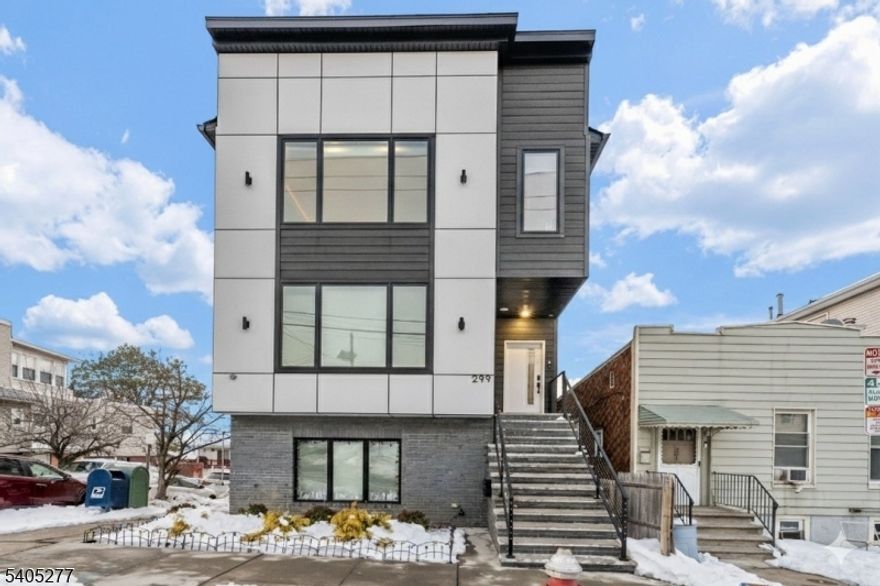 Welcome to 299 Columbia Ave, Unit 1 an impressive duplex residence in the heart of Jersey City Heights. This turn-key home perfectly balances expansive living with city convenience, highlighted by an open-concept main level with vaulted ceilings and abundant natural light.This property features:  3 Bedrooms / 2.5 Baths: Generously sized with modern finishes, hardwood floors, and custom window treatments recently installed throughout the home.  Expansive Family Room: A finished versatile lower-level entertaining area complete with a wet bar and convenient powder room.  Finished Basement: Features rare 10-foot+ ceilings, creating an incredibly open  atmosphere perfect for a home gym, media room, or guest space.  Private Parking & Triple Access: Includes a coveted dedicated driveway and (3) separate entry points for maximum convenience: front door, family room walkout, and side entrance.  Prime Location: Situated just moments from Washington Park, vibrant dining, and effortless transit options to NYC.Inventory of this caliber moves fast. Submit your best offer today.