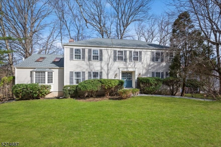 Stately, Well-Maintained Colonial with 3,200+ sq ft of living space including 4 Bed / 2.5 baths located in a quiet residential neighborhood of Morristown near schools, multiple parks, NJ Transit direct train to NYC, and downtown shopping and dining. An inviting flagstone foyer welcomes you into the gracious main level with beautiful hardwood floors, flanked by a living room and formal dining room with chair rail detail. A spacious kitchen has ample oak cabinetry, recessed lighting, large center island with seating, a sunny breakfast nook with sliding door access to the rear. Past a discreet powder room is a cozy office/library with a fireplace, built-in shelving, and bay window with backyard vistas. French doors in the living room take you to a welcoming family room addition boasting a stunning vaulted and beamed ceiling with skylights. Upstairs you'll find your tranquil primary retreat with an oversized bedroom, dressing area with vanity, huge walk-in closet, and en-suite bath with stall shower. Three more bedrooms each have generous closet space and are serviced by a full hall bath with dual storage vanity and shower over tub. There's additional living space on the fully finished walk-out lower level, which hosts a wood-paneled recreation room with access to the attached 2-car garage, plus a separate room, utilities, and several spaces for storage. Enjoy warm-weather cookouts or sipping morning coffee on the oversized deck overlooking a serene backyard lined with trees.