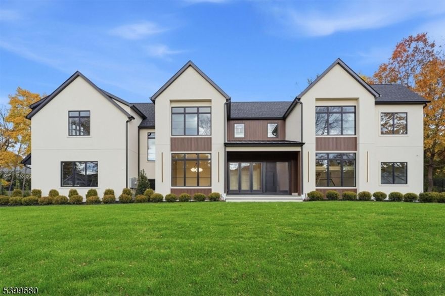 Another stunning custom home by renowned Fermano Builders, perfectly situated on Demarests prestigious east side, offering over 7,200 sq ft of meticulously crafted luxury living on .55 acre. Designed by award-winning FDS Architects, this home features a dramatic two-story foyer w/ a floating glass-enclosed staircase leading into a breathtaking double-height family room w/ a striking stone-and-wood clad fireplace. A sophisticated glass wine display elegantly connects to the formal dining room. The gourmet kitchen is a chefs dream, boasting top-of-the-line stainless steel appliances, double islands, a walk-in pantry, a sun-drenched breakfast room, and a stylish wet bar just off the kitchen, perfect for entertaining. The first floor is enhanced by 10-foot ceilings and includes a refined office/library, a sumptuous ensuite bedroom/cabana, and two beautifully appointed powder rooms. Upstairs, the oversized primary suite features a serene sitting area, two expansive walk-in closets, and a spa-like bath w/ soaking tub and oversized shower, and complemented by three additional ensuite bedrooms and a convenient laundry room. The fully finished lower level provides a complete entertainment haven w/ a rec room, deluxe media room, gym, versatile ensuite bedroom, game room, and sleek wet bar. Additional highlights include a three-car garage, a covered patio, and room for a pool. This rare residence blends modern luxury, sophisticated design, and an unrivaled Demarest location.