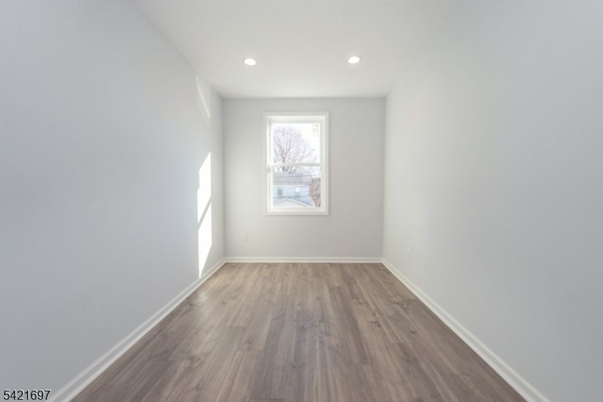 Turnkey legal 2-family in the heart of Essex County! Completely renovated in 2024 with high-end finishes throughout. Featuring 4 bedrooms and 3 full bathrooms. This income-producing property is move-in ready with zero work needed. Commuters will love the connectivity. NYC is less than 20 miles away, making this an unbeatable location for owner occupants, tenants, and investors alike. Move in and rent the other unit to lower your cost of living! Unit 1 (1ST Floor): 2 Bed 2 Full Bath. Open-concept layout with designer kitchen featuring gray shaker cabinets, charcoal quartz-style countertops, glossy subway tile backsplash, matte black hardware, and stainless steel gas appliances in both units. Two full renovated bathrooms with tile surrounds and spa-inspired matte black fixtures. Unit 2 (2nd Floor): 2 Bed   1 Full Bath. Sun-drenched open living and dining area with large windows. Matching designer kitchen, fully renovated bath with tile, and . Bright, airy, and move-in ready. Property Highlights: Recessed LED lighting, beautiful flooring throughout,  Matte black fixtures. Full unfinished basement accessible to both units with exit and ample storage, Detached 2-car garage with a great backyard. On-street & off-street parking right off a one-way street. Classic stone facade Location: Minutes to Newark Airport, NJ Turnpike, GS Parkway, Route 78, NJ Transit bus & rail, and less than 20 miles to NYC. A rare opportunity to own a turnkey in one of the county's most accessible locations