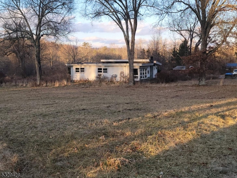 This 3 Bedroom fixer upper is in picturesque northern Sussex County near the NY/NJ/PA borders where nature abounds. The cleared, level land holds many possibilities. The house has hardwood floors and 2 fieldstone fireplaces. The plumbing and electricity have been updated. There is an underground oil tank and an abandoned swimming pool (on the right side of the house). Well and septic information are unknown. The second bathroom is in the basement. House is being sold As Is.