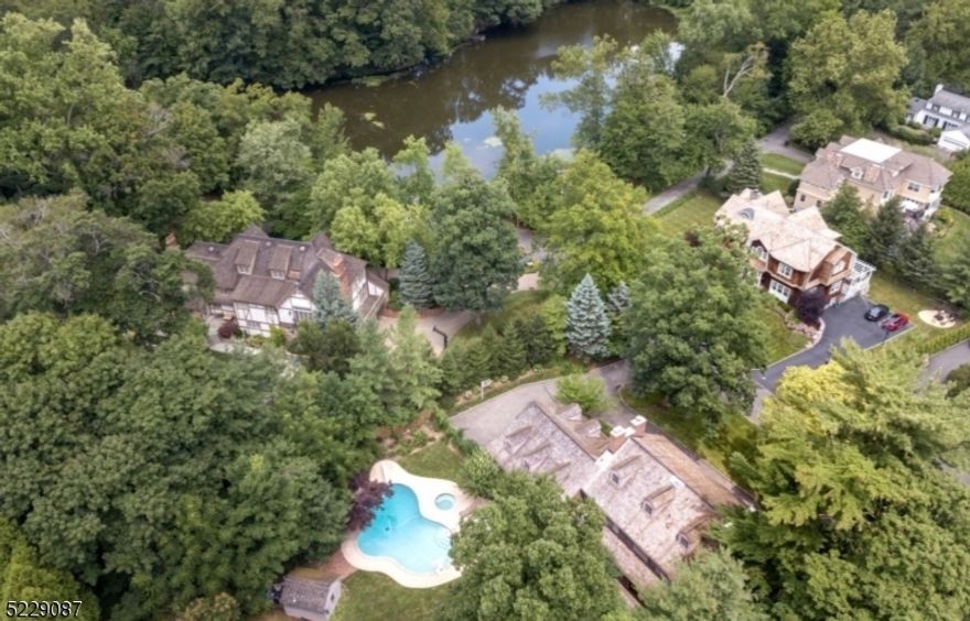 Opportunity of a lifetime to live in the most desirable location in Short Hills - renovate this Custom built All Brick Colonial built in 1981 or Build Your Dream Home on this .69 acre lot on a quiet cul de sac in the Historic District right by the pond, walking distance to the Short Hills Train Station (just 0.7 miles!). Home has a pool, a grand 3-story entrance hall, fireplaces in the living, dining, family rooms, as well as the primary suite and another bedroom. Every room in back of the house has easy access to the deck and pool, hot tub and totally private, fenced rear property. Easy 1st level access to attached 3-car garage. Primary suite and 3 more bedrooms that had 2 baths (one is en-suite). The 3rd level has a skylight. Lower level is unfinished and you can finish to your specifications. House is being sold in "as is" condition. Bus service is provided to highly rated Hartshorn Elementary School, Millburn Middle & High School.