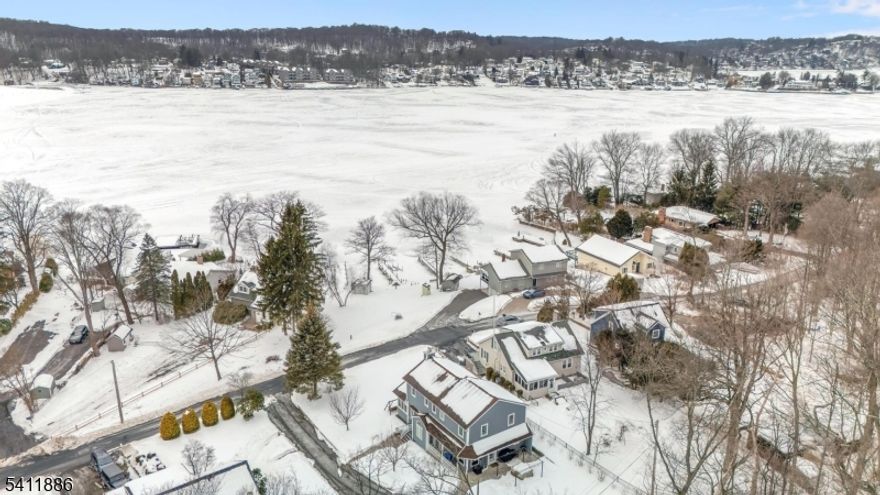 Lakefront living at it's finest - stunning contemporary colonial on Lake Hopatcong. Welcome to your dream home on beautiful Lake Hopatcong. This exceptional 3 bedroom, 2.5 bath contemporary colonial offers the perfect blend of elegance, comfort and waterfront lifestyle - complete with lake access and a gorgeous dock just steps from your door. Step inside to discover a bright, open layout filled with natural light, and thoughtfully designed living spaces. The spacious living and dining areas are perfect for entertaining, while the modern kitchen features quality finishes, ample cabinetry and a seamless flow into the heart of the home. Upstairs, you will find three generously sized bedrooms, including a serene primary suite with private bath, sitting room and peaceful views. With additional 1.5 beautifully appointed bathrooms, convenience and style meet at every turn. Outside is where this home truly shines. Enjoy morning coffee overlooking the water, sunset dinners on the patio, and endless days of boating, fishing or simply relaxing on your patio at the dock. The 2 car garage provides plenty of storage for vehicles and lake gear alike. Located in sought after community near parks, walking trails, golf and dining on Lake Hopatcong's many lakefront restaurants. It's a rare opportunity to live the lakefront lifestyle every day. Don't miss your chance to own a slide of waterfront paradise.