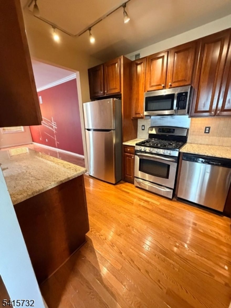 Light-filled, spacious end-unit townhome in a highly desirable community location!The ground floor offers a bright great room with a French door leading to a private patio overlooking lush landscaping and a serene pond with a fountain.The first floor includes a formal dining room with a bay window, and an updated kitchen featuring cherry cabinets and stainless-steel appliances. A convenient powder room completes this level.Upstairs, you'll find two generously sized bedrooms, two full baths, and a laundry area. The primary bedroom boasts a vaulted ceiling and an en-suite bathroom with a Jacuzzi tub, separate shower, and dual-sink vanity. The second bedroom includes two closets and skylights.Additional features include a one-car garage with opener and ample storage.The community offers fantastic amenities: a brand-new playground, outdoor pool, tennis courts, clubroom, and fitness room. NYC transportation and shopping options (Target, Stop & Shop, and more) are just minutes away. Wilshire also provides guest parking and sidewalks throughout the neighborhood.  Fireplace in living room is non functioning.