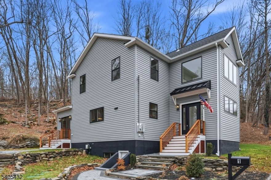 Newly constructed turn-key contemporary-style living. Step into a striking two-story entry foyer featuring a quarter-turn staircase accented by a modern multi-light glass globe chandelier. The 1st first floor highlights an expansive open concept with a formal living area featuring two skylights, a fireplace, and adjacent sliding glass doors to the front patio/yard. The dining area showcases a custom bar, sink, and wine cooler. The chef's kitchen is equipped with a waterfall-style center island, brand new stainless steel appliances, and a built-in microwave tucked into the island for added convenience. Additional 1st floor private office and guest powder room. The 2nd floor - Master Bedroom Suite features top-tier walk-in closets and a luxurious Master bathroom, three bedrooms, and a bath. A well-appointed laundry room, sink, and cabinetry are conveniently located on the same level. Bonus attic space for extra storage, dual-zone HVAC system, a walk-out basement featuring a utility room, and additional storage space. Exclusive private driveways. Located minutes from Blair Academy boarding school, local farms, shopping, dining, and major commuter routes, with NYC transportation under 30 minutes.