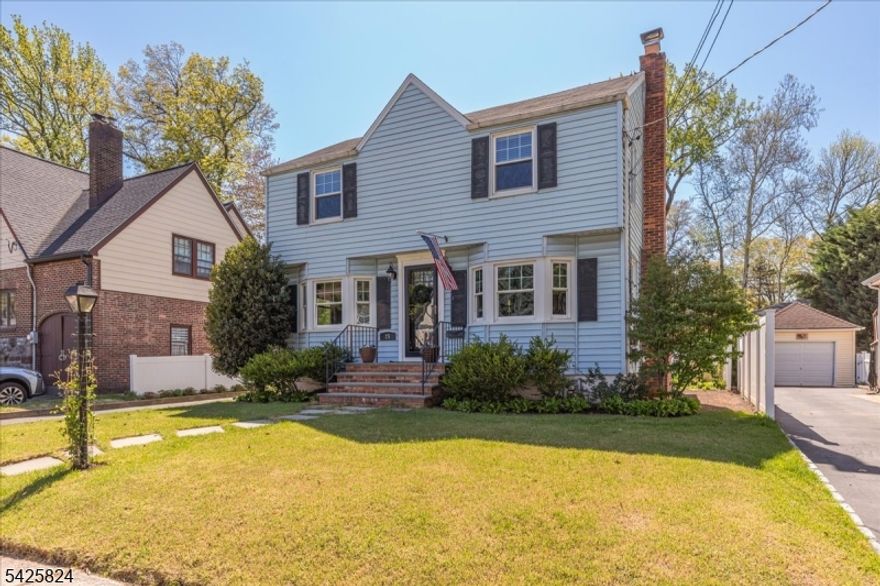 Charming Classic Cranford Colonial, lovingly cared for and available for the 1st time in 47 years! This 3-bedroom, 1.5-bath home is filled with warmth and character, featuring hardwood floors, arched doorways and special touches throughout. Central air (CAC) for year-round comfort. The inviting living room with a wood-burning fireplace adds timeless appeal, while the spacious dining room is perfect for gatherings and entertaining. The updated kitchen with granite countertops and stainless-steel appliances opens seamlessly to the family room - perfect for everyday living. A renovated first-floor powder room rounds out the 1st fl. Upstairs offers three bedrooms, a full bath, and a cozy window niche. A clean, unfinished basement provides excellent potential to customize and expand to suit your needs. The outdoor space is truly special - a gardener's dream with spectacular perennial gardens create a private, storybook setting, complemented by a patio and firepit area for added entertaining spaces. A long driveway and 1-car detached garage provide ample parking. Ideally located just moments from the bike and walking paths leading to local schools and nearby pool. This home is an absolute gem! This house is not located in the flood zone.