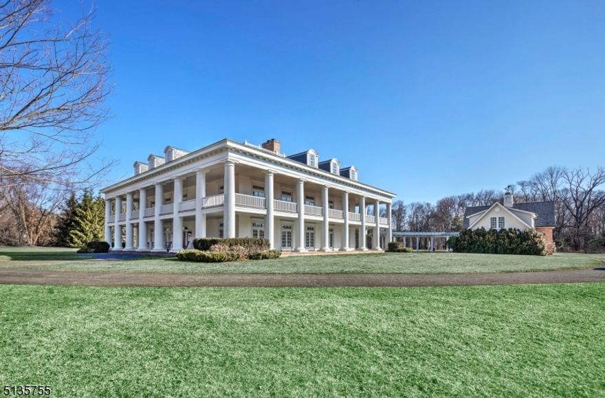 Inspired by Greek Revival architecture, the iconic estate set on the Bernardsville Mountain exemplifies subtle elegance and architectural distinctive classic excellence. Known for grand scale and symmetry, encircled by Doric columns, french doors & wrap around verandas, this a legacy property offering two spacious living structures designed by local prominent architect Hiland Hall Turner.  This is a high quality home from the superb design to the exceptional build and execution using the finest materials. The owners spared no expense in creating a masterpiece w an emphasis on inviting elegance and the comfort of Southern living. The architectural details & design is evident in well-proportioned curated rms w 12' ceilings & superlative millwork.  Impressively appointed finishes & architectural significance throughout the interior are magazine worthy & irreplaceable at this price.  The mansion has a square floor plan with two story covered porches on all four sides.  The plan is organized around a central stair hall as common area to access all spaces of both the first and second floors.  Seamless movement between indoors and the rest of its acreage add to the peace, tranquility and security of this iconic estate. This is a one-of-a-kind style of a bygone era of American architecture during a specific moment in history for the most discerning client!
