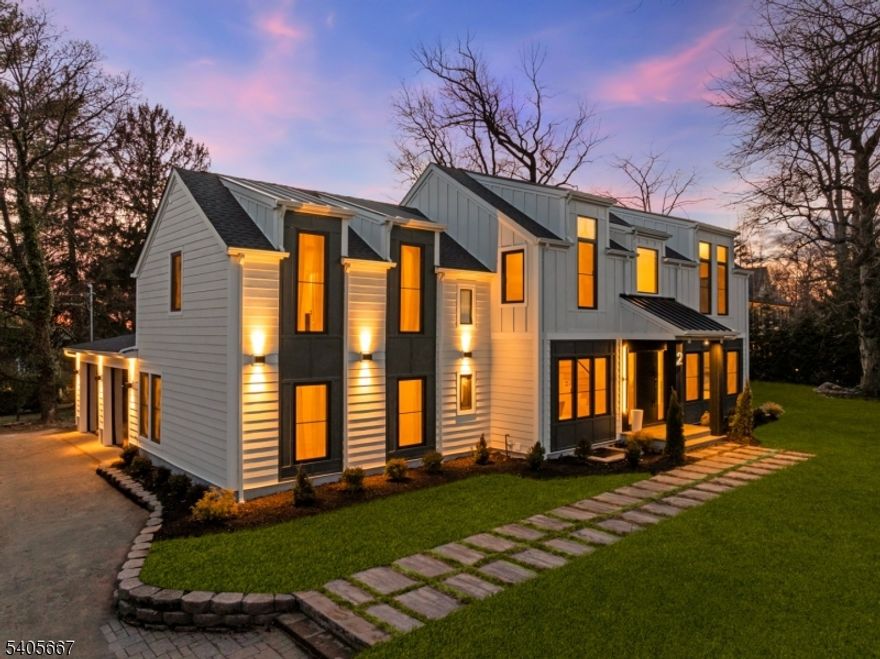 An EXCEPTIONAL, COMPLETELY RE-BUILT home designed by renowned architect Thomas Baio, offering 6 oversized bedrooms and 6.5 baths across three beautifully finished levels, on a fabulous level lot.  The home makes a striking first impression with its modern, maintenance-free facade, standing-seam metal roof accents, and curated architectural lighting. A dramatic double-height foyer with sculptural Sonneman chandelier introduces interiors defined by a refined "quiet luxury aesthetic, wide-plank oak floors, and a cohesive modern neutral palette. Bathed in natural light, the main level features expansive formal living and dining rooms, a spectacular great room with an indoor-outdoor fireplace, and oversized windows. The chef's kitchen is a true showpiece, anchored by a waterfall island in Volupia Green quartzite, custom cabinetry, designer appliances and fixtures, and a fully equipped walk-through pantry and prep kitchen. The first floor also features a private bedroom suite, a mudroom, and a powder room. Upstairs, every bedroom is en-suite, including a serene primary suite with walk-in closets, spa bath finished in Venetian Vendome stone, and a flexible sitting room or office. The finished lower level features a large entertainment lounge with a wet bar, a bedroom, a full bath, a playroom, and bonus spaces. Flat backyard with stone patio and room for pool. Oversized two-car garage, brand-new roof, and mechanical systems. Rare opportunity to own a design-driven, turnkey residence