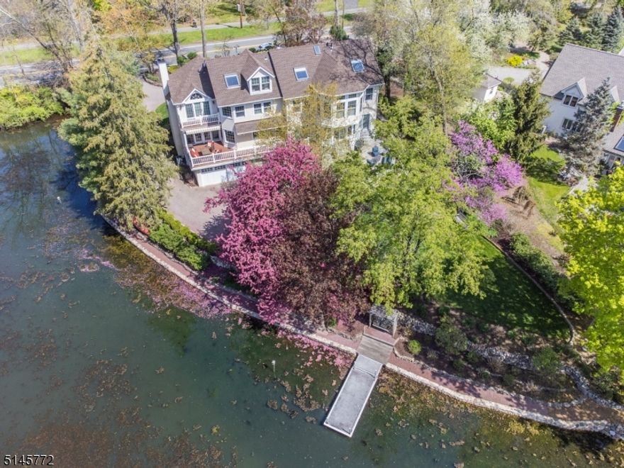 Stunning, lakefront colonial set on an enchanting, manicured property boasts breathtaking views from almost every room. Lovingly renovated and meticulously maintained, enjoy all high end amenities in this exquisite gem! Gleaming hardwood floors throughout, exquisite architectural details, magnificent windows & French doors as well as spectacular outdoor entertaining spaces result in absolute perfection here!  From the fabulous gourmet kitchen open to the inviting family room w/ stone fireplace to the expansive LR with slate frpl., elegant formal DR and spectacular primary suite w/ frpl. , private balcony and luxurious primary bath.. this home has it all! Spacious bedrooms, all  updated baths, 2nd floor incredible office space with walls of windows, 2nd floor laundry and a walk out LL w/ gym, recreation room & guest suite! Boasting a 4 car tandem, heated garage, newer roof and high efficiency boiler, inground sprinklers, security system w/ cameras, electric fence, Tesla charger and more.. it has all been done here! Just move right in and commune with nature enjoying glistening  lake views from the gorgeous bluestone patio  or expansive deck. Fish or kayak from the private dock or ice skate in the winter. You have arrived, enjoy the tranquility!