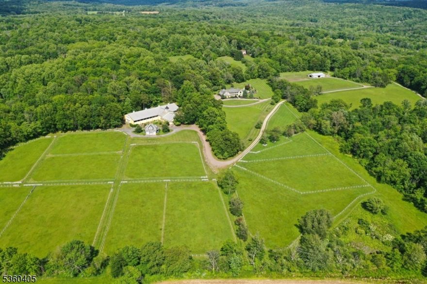 Luxury for you and your horses at Sunset Farm! Completely secluded w expansive views this extraordinary 60 acre horse property w 45 acres of paddocks & fields has 2 separate lots w custom 5134 sq ft home offering a flexible floor plan, carriage house, 2 barns w 22 stalls total & steel frame construction indoor Olympic-sized dressage arena w exceptional observation meeting room. Sensational 2-story great room has exposed beams, floor to ceiling local fieldstone surround fireplace & spiral staircase to overlook & lounge. Gourmet kitchen w multiple islands, copper hood & high-end appliances including Wolf & Sub Zero. Primary bedroom wing has 2 walk-in closet/dressing rooms w custom cabinetry organizers, luxurious bath w huge steam shower, sitting room & opens to balcony w amazing views. Resort-style living w in-ground pool, spa, stone walls w waterfall features, paver patios & expansive entertaining pavilion. Office w private entrance. Finished basement w billiard room, gym, rec & powder room. Superior craftmanship in the main equestrian facility w 6 cupolas, tack rooms, wash/grooming stalls, bathrooms, lounge areas, Dutch doors, interlocking rubber floors, hay loft w drops & automatic waterers in stalls & paddocks.75x48 Morton building. Brick carriage house has 6-bedroom septic in place for future expansion. Other highlights include whole house generator, solar panels, copper gutters & leaders, Epi decks, mahogany & white oak floors, Viesmann heating system, Too much to list!