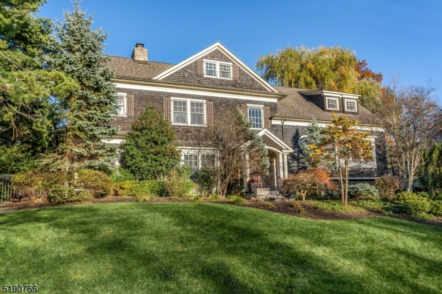 Proudly perched on a grassy knoll, this classic beauty is ideally situated on a quiet tree-lined street in the highly sought-after Woodfield Estates section of Short Hills, offering complete privacy and a spacious poolside backyard. Renovated to exacting standards by Geiss Custom Builders with a neutral designer palette, high-end finishes and luxurious upgrades including high ceilings and custom millwork throughout. The large open floor plan impresses with a soaring two-story foyer, first floor den, first floor office, several French doors to rear pergolas, three gas fireplaces and a two-story family room next to a gourmet kitchen with custom cabinetry and high-end appliances. The second floor features a luxurious primary suite that soothes the senses with a cozy gas fireplace, two walk-in closets and a spa-like bath, three additional en-suite bedrooms and a second laundry center. Two expansive and separately accessed third floor areas including a private in-law suite while a wonderful lower level with rec room, media room, laundry center and full bath offers plenty of space for all. Outside the bespoke experience continues on generous grounds with a heated in-ground salt-water pool, large patios for gatherings and a lush private yard for outdoor activities. Thoughtful upgrades include in-ceiling speakers in nearly every room, mudroom with abundant storage and radiantly heated flooring, heated oversized 2-car garage and 36KW generator to ensure that the fun never ends.