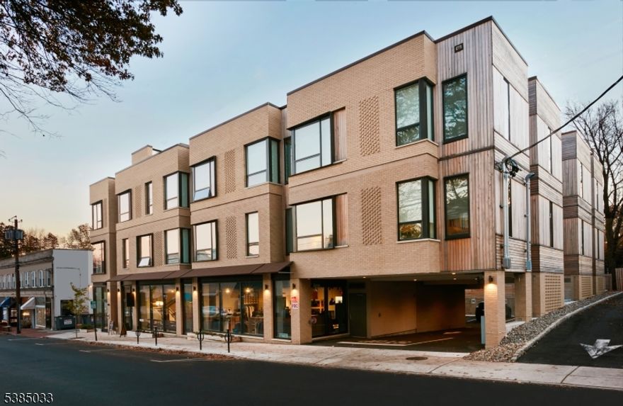 Stunning modern 2 Bedroom/2 Bath apartment in this stylish 2022 new build in the heart of vibrant Maplewood Village. Unbeatable convenience just steps from top-ranked restaurants and favorite local eateries, boutique style shops, and midtown direct trains to NYC/Hoboken. Luxury building offers secured street-level entry, elevator, available off-street parking, bike storage, and an incredible private roof-top terrace for residents to enjoy with views of the downtown area, seating for lounging and dining, and an interior 'club house' offering work space, comfortable seating, and restrooms. Well-appointed units feature high-end kitchens with gleaming quartz counters, islands and slab backsplash, full-height soft-close cabinetry and high-efficiency appliances by LG and Samsung. The oversized windows are fitted with custom shades. The baths feature glass-enclosed showers and sink vanities with storage. The primary bedroom includes 2 closets and linen storage in the en-suite bath. In-unit LG washer/dryers and coat closets add to the convenience. Parking is available for an extra fee. EV chargers on-site.