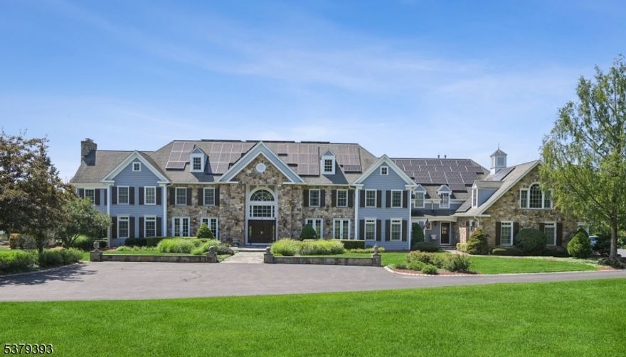 Welcome to this magnificent custom Colonial estate, gracefully set on over 10 acres of pristine land. Offering 7 bedrooms and 7.3 baths, this grand residence showcases exceptional craftsmanship and timeless elegance throughout. A stately double staircase greets you in the grand foyer, setting the tone for the home's refined interiors. The chef's eat-in kitchen features fine cabinetry, high-end appliances, a butler's pantry, and thoughtfully designed spaces ideal for entertaining. The family room is adorned with soaring ceilings and expansive windows that flood the space with natural light. Rich mahogany finishes, immaculate red oak flooring, and detailed marble accents elevate the home's interior. Enjoy the warmth and ambiance of seven fireplaces throughout, including in the sophisticated private home offices. The expansive primary suite boasts serene views, a generous sitting room, two fireplaces and a spa-like bath with a steam shower. Five guest bedrooms offers their own private ensuite bath. The walk-out lower level features a custom temperature-controlled wine room, massive rec. room with a custom wet bar, a home theater and an exercise room while the exterior offers a covered deck with fireplace, multiple patios and a heated saltwater pool. Additional highlights include two car lifts in the finished garage, a whole-house generator, a reverse osmosis water filtration system & much more! This extraordinary estate must be experienced in person to be truly appreciated.