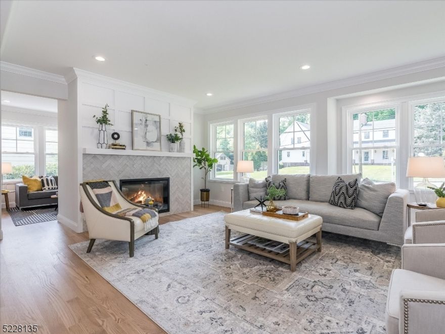 All NEWLY RENOVATED modern, bright and beautifully designed Colonial home located on one of the most sought after streets in Westfield. Graceful exterior features include a gambrel roof, iconic double-hung windows, and wide plank composite siding. An open and flowing floor plan caters to the demands of modern living. Chef's dream kitchen w/ quartz countertops, custom cabinetry, walk-in pantry, immense island, high-end ss appliances & coffee/wine bar. The open layout seamlessly connects the kitchen to the dining area and expansive family room with a stunning WBF and surround. Separate DR, two office/play spaces and PR complete the first level. Prewired for TVs, Data, Wifi Multi-Room Audio and Surround Sound. Sliding doors off the kitchen open to a generous composite deck for al fresco enjoyment. Ascending the staircase, discover a serene master suite with feature accent wall and a spa like ensuite bath. Three add'l bright and airy bedrooms, hall bath w dbl sink, and laundry complete the 2nd floor. A fabulous 3rd floor offers a 5th bedroom, beautiful full bath and open bonus space to be enjoyed for work, play or leisure. Travel down to the lower level to discover a 6th bedroom, full bath, and recreation space with entertainment bar.  Outdoor living is embraced to the fullest with a huge paver patio, accessed from the lower level, flowing to an expansive flat yard with ample space for a pool and creating an idyllic setting for outdoor recreation, relaxation, and entertainment.