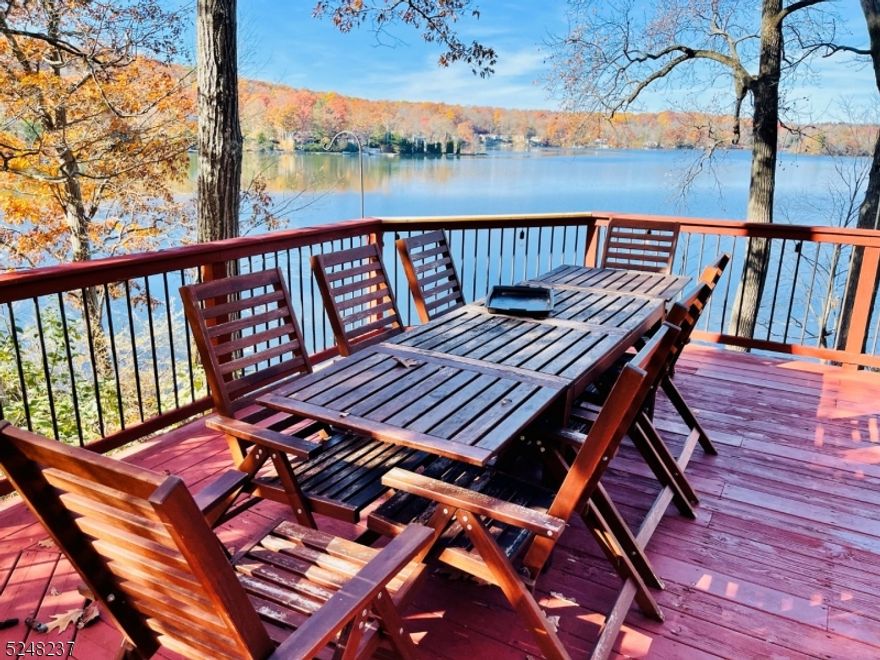 This exceptionally charming fully furnished lake-house is perched on a slope overlooking Highland Lake. This home is immersed amongst the trees and surrounding gardens offering privacy and a spectacular view of the entire lake. Some say it's the best view on the lake. Whether you live year-round or vacation here it doesn't get better than this. Take in the glorious view from the large floor to ceiling windows while relaxing in the living/dining room that has a cathedral ceiling and stone wood burning fireplace w/insert. The living room door opens to a large wrap-around deck with a table and chairs that seat 10 and a BBQ for grilling. A peaceful place to relax and take in nature. The kitchen is fully equipped and ready for everyday meal prep or entertaining guests. There are 2 bedrooms and a loft with queen beds and a beautifully renovated bathroom on this upper level. The lower level has a primary suite with a second stone fireplace, a queen bed and a queen-sized sofa bed. The windows and French doors that lead to the lake offer another lakeview. A second tastefully renovated bathroom with a shower and heated floor, a laundry room and utility room complete this level. There is plenty to do at the lake, in summer, swim, boat, sunbathe from your private dock. Only electric boats allowed to assure peace & quiet. Mountain Creek is just minutes away with its water park & ski slopes for all year-round fun