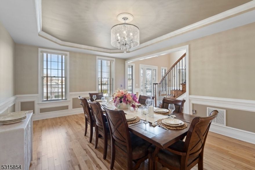 Exquisite Toll Brothers Hampton model boasts 6 bedrooms, 6 bathrooms with approximately 5781 sq. ft. After entering through the stately doorway, you're welcomed by a curved butterfly staircase and 2-story foyer with crystal chandelier. The first floor features a spacious conservatory of the living room, first floor bedroom/ full bathroom, gas fireplace gourmet chefs kitchen with high end appliances and bumped out eating area looking out onto the maintenance free deck. Upstairs each of 4 bedrooms have their own bathrooms and large closets. Master bedroom /The owner's suite is spectacular with tray ceiling, sitting area, 2 walk-in closets, and a five piece suite bathroom, 2 vanities, large shower room, soaking tub and private stall. The basement has a full bar, family room, bedroom, full bathroom with sauna and plenty of space for entertaining. Amazing backyard with lovely inground pool featuring an attached hot tub, sun shelf, seating and table. Perfect for cooling off on hot summer days or hosting poolside gatherings. Not to be overlooked is a large deck that offers plenty of space for entertaining and enjoying the outdoors. The home also includes numerous other amenities, wired security system, outdoor lighting, and more. This home truly offers the best of both worlds - a classic colonial-style interior with modern amenities and a backyard that feels like a private resort Custom paver driveway & tiled garage too! Close to Route 9, shopping, restaurants and the jersey shore.