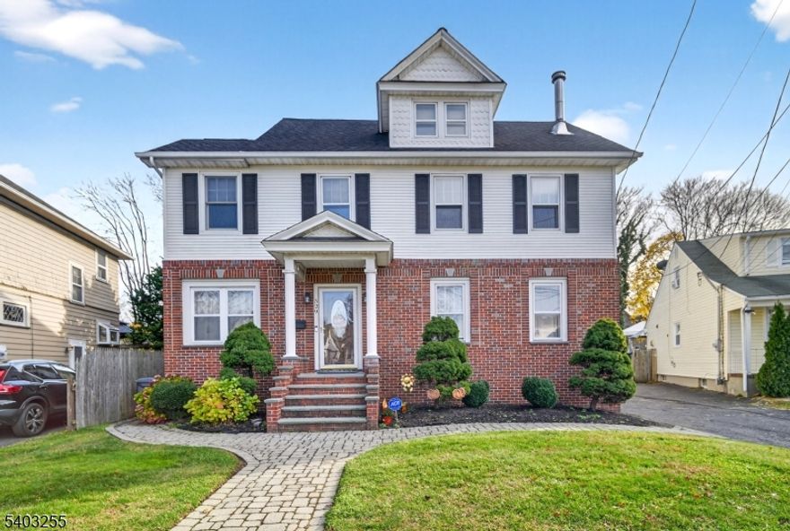 This Classic Brick-front Colonial has been beautifully updated and expanded with a generous addition, offering 4 Bedrooms, 2.5 Baths, and over 3000 SF of Living Space! The main level offers rich hardwood floors, classic trim work, wainscoting, and an inviting living room with wood-burning stove. The impressive formal dining room was made for entertaining, comfortably accommodating large gatherings (15+ people). The updated chef's kitchen features stylish cabinetry, stainless steel appliances, generous counter space, a breakfast bar, and sliding doors to the rear deck. Additional living space includes an oversized FR with cathedral ceiling, recessed lighting, skylights, and french doors that open to a cozy home office. Upstairs offers four generously sized bedrooms, the main bath, and a finished walk-up attic offering bonus living space and half bath. There is also a full basement providing ample storage and laundry facilities. Outside, enjoy your own private oasis with fully fenced in backyard, deck, and a sprawling paver patio surrounding the in-ground gunite pool and hot tub. A detached 2 car garage further enhances this standout property. Excellent location, only a few blocks from downtown shopping, dining, and the train station. This home truly has it all!