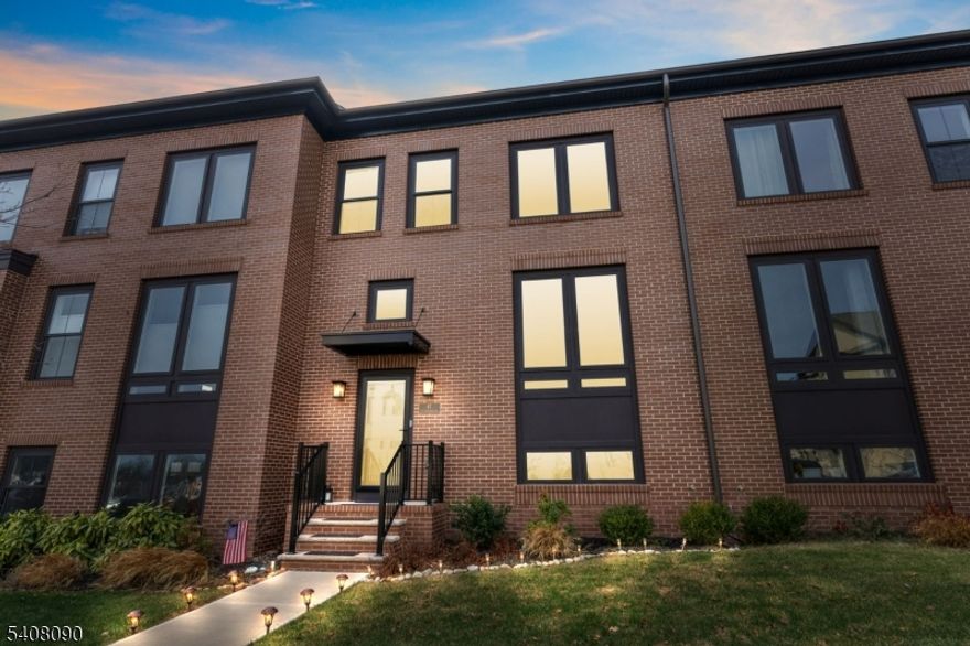 Welcome to luxury living in Montgomery Crossing. Built in 2023, this beautifully upgraded, nearly new 2,613 sq. ft. brick-front interior home offers modern design, refined finishes, & exceptional walkability to Village Walk shopping & the future Montgomery Promenade, to be completed in 2026. The bright, open first floor features a spacious family room & dining area, ideal for everyday living & entertaining. The chef's kitchen showcases quartz countertops, an oversized island, farm sink, custom tile backsplash, stainless steel appliances, designer wrought-iron railings, under-cabinet lighting, & recessed lighting throughout. A walk-in pantry is conveniently located near the wide one-car garage. Sliding doors lead to a private Trex deck overlooking a fenced-in yard with custom stone pavers and a retractable awning, creating seamless indoor-outdoor living. The finished basement offers flexible space for a rec room, gym, office, or guest area, along with a half bath and ample storage. Upstairs, the primary suite features a tray ceiling, generous closets, and an upgraded spa-like bath. Two additional bedrooms, a full bath, and upper-level laundry complete the home. With three bedrooms, two full baths, two half baths, a finished basement, private yard, garage, & designer upgrades throughout, this turnkey townhome delivers luxury, comfort, & convenience. Opportunities like this are rare in Montgomery Crossing. Don't miss your second chance homes like this rarely become available.