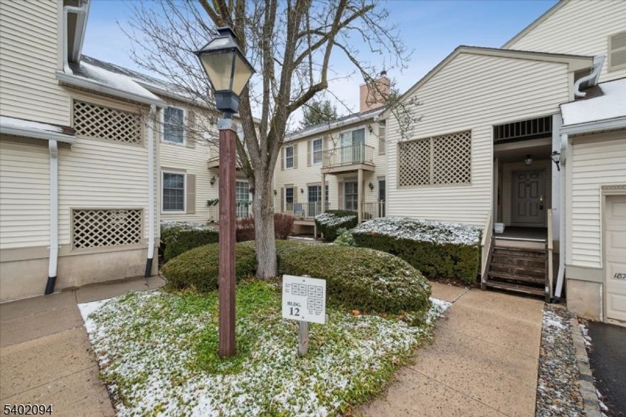 Beautifully updated first-floor, two-bedroom end unit in the highly sought-after Spring Ridge community. This desirable Drexel model offers a bright, modern living space featuring fresh paint and wood-laminate flooring. The spacious living room includes a sliding glass door leading to a large deck, perfect for relaxing or entertaining. A formal dining room provides ample space for gatherings and everyday meals. Updated kitchen boasts a window, sleek stainless-steel appliances, granite countertops and backsplash. Both bedrooms are carpeted and are equipped with ceiling fans for added comfort. The updated bathroom features a tub/shower combination with glass sliders and a stylish vanity. Additional highlights include an in-unit washer and dryer, a private storage room, and a garage with an additional parking space for added convenience. Enjoy the peaceful setting of Spring Ridge, offering 326 acres of meticulously maintained grounds and bordering over 100 acres of protected natural land. Community amenities include a clubhouse, playground, bocce court, bicycle paths, tennis court, and an in-ground pool. Ideally located with easy access to Route I-78 and nearby shopping, this home offers the perfect balance of tranquility and convenience. Please note: no dogs are permitted in Spring Ridge.