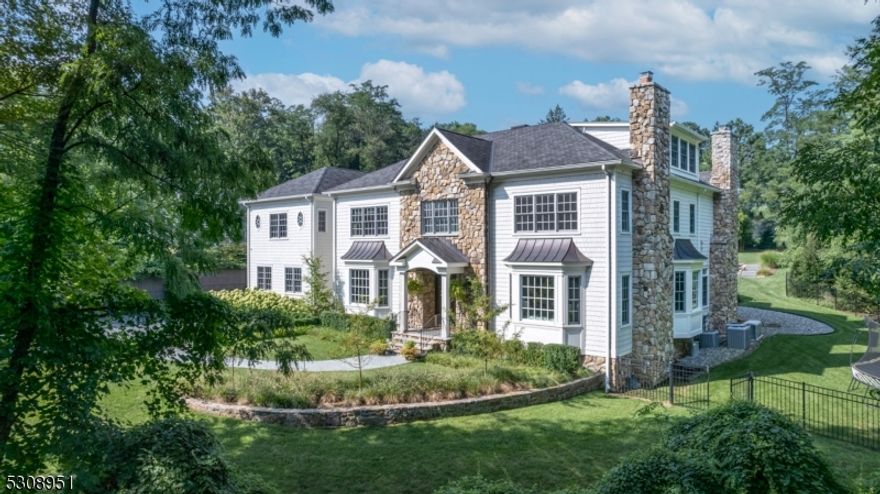 From the moment you drive onto the property, you will be captivated by this stunning 8 bed/10bath oasis. The lush property is masterfully designed with mature landscaping, bluestone walkways, & resort-style backyard. The double door entrance & grand foyer set the tone for the high ceilings & exquisite features throughout. Radiant heat on all 4 floors, & 3-car garage. Formal LR with FP & DR with elegant wainscotting are gracious & inviting. 1st floor boasts powder room off mudroom & full bath near private bedroom/office. The gourmet kitchen is a chef's dream with 10ft island, 48 Wolf range, double size refrigerator/freezer, wall oven, 2 beverage drawers & 2 dishwashers. Fabulous butler's pantry with walk-in pantry attached. FR w/ wet bar is anchored by a large stone FP, windows overlooking luxurious backyard. 4 season cathedral ceiling sunroom is truly magical from summer days to cozy winter nights. Enviable primary suite features FP, huge his & her closets & spa bath. 4 additional ensuite bedrooms & laundry room complete 2nd floor. 3rd floor hosts massive bonus room, full bath & bedroom. Basement is entertainers dream with large rec room, kitchen, in-home theatre, ensuite bedroom with FP, state of art fitness room & half bath. The real SHOWSTOPPER is the backyard. Double patios, outdoor kitchen. Relax & unwind in 18x10 GUNITE SALT WATER POOL heated for year round use. Large gazebo w/ gas fire pit & TV.  Outdoor lighting & Sonos throughout! Full house generator.