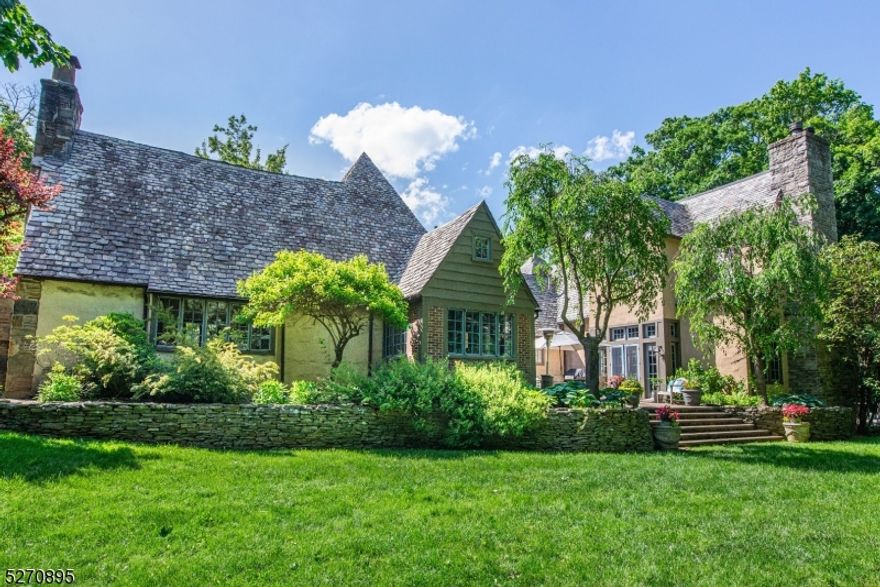 Magnificent Cotswold-style Arts & Crafts Tudor home on 2/3 acre in Montclair's Estate Section. Designed by renowned architect Frank Joseph Forster & seamlessly expanded in 2011. 6 BRs, 5.1 baths, luxurious primary suite, gourmet EIK, sauna, heated in-ground pool, herb garden, 2-car attached garage, circular drive, wrought-iron accents, wide-plank floors, beamed ceilings & expansive grounds. Light-filled living rm w half-timber beamed ceiling & Juliet balcony. Formal dining rm w windows on 3 sides & access to courtyard patio. Sitting rm w built-ins, recessed lighting. Full bath w double sinks & BR w FP. Window-filled EIK w French doors to courtyard & herb garden, 2 center islands, pendant lights, custom cabinets, SS appls, stone counters, workstation, dining area & garage access. Mudrm, laundry rm, powder rm, closet, access to basement, private parking area w outside garage entry. Huge fam rm w gas FP, beamed ceiling, wood panels, doors to pool & courtyard. Stunning 2-story staircase to expansive 2nd fl w 5 well-appointed BRs, each w ensuite bath. Spa-inspired primary suite w vaulted ceilings, WB FP, 2 walk-in closets w built-ins & pocket doors; French doors to balcony over pool. Ensuite bath w stone fl, luxurious walk-in shower, soaking tub, 2 vanity sinks, recessed lights & laundry chute. Huge finished basement w media rm, home gym, rec rm, sauna, 3 storage areas & utility rm. Near schools, culture, dining & transport. On National Registry of Historic Places. Make it yours!