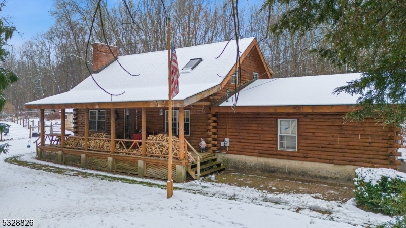 OPEN HOUSES CANCELLED.  Nestled on over 13 bucolic acres in picturesque Hampton Township, this charming farmette offers endless possibilities. Whether you dream of a small farm or exploring subdivision potential, this property is ready to accommodate your vision. The centerpiece is a warm and inviting log cabin with a welcoming covered front porch, perfect for enjoying serene country views. Inside, the cathedral-ceilinged living room showcases exposed log rafters, finished log walls, and a wood stove on a raised stone hearth, creating a cozy focal point. The primary bedroom is conveniently located on the first floor, while a spacious loft and two additional bedrooms upstairs provide plenty of room for guests.The home is thoughtfully equipped with hardwired generator capabilities and Boasts a full unfinished basement with poured foundation walls, offering excellent storage or the potential for finishing to suit your needs. Several outbuildings with electric provide added utility, and 8 acres of the property are farm-assessed for lower taxes. Despite its peaceful rural setting, this property is just a short drive from shopping and local eateries, combining country charm with modern convenience. Don't miss this incredible opportunity to own a piece of paradise!