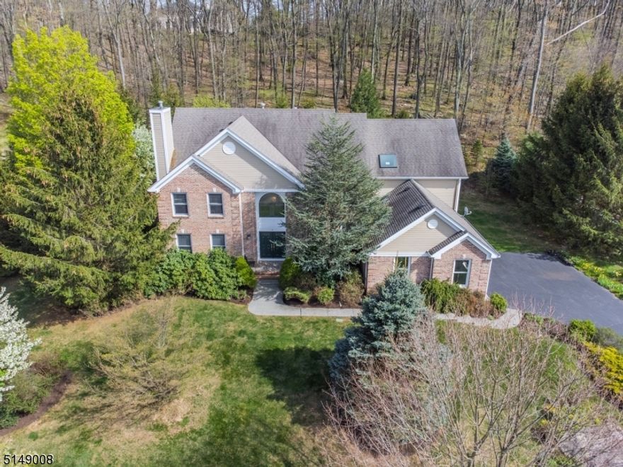 Stately Colonial, Understated Elegance! Nestled in one of Denville's most desirable neighborhoods, this home offers an upscale lifestyle on a quiet Cul-De-Sac. Prominently set on a large, level lot backed against a protected wooded area. Bright, open floor plan. Many high end features throughout. A grand home accented w/architectural details; high ceilings, wainscoting, curved walls & moldings. A showcase home with several customizations! Paramount Homes, Georgetown I floorplan with enlarged layout & added square footage give this home an edge. Updated kitchen w/coriander countertops & gourmet SS appliances. Cathedral ceilings & floor to ceiling windows in Family Room. Formal Dining & Living Rooms bookend the striking 2 story Foyer w/custom made stained glass window & chandeliers. Entertain with Flair! Extra bdrm/office on 1st floor. Upstairs, the primary suite features a large bath, 2 walk-in closets & sitting area. 3 more bdrms & bath. Full basement w/high ceilings- bonus living or storage plus oversized 3 car garage. Glass sliders to deck & landscaped backyard oasis offers a ton of privacy amidst mature trees & perennial gardens. Great location, just mins from Union Hills Shopping Center, Denville's bustling DWTN, Morristown Green, NYC-Direct transport & easy access to major hwys. Public utilities.