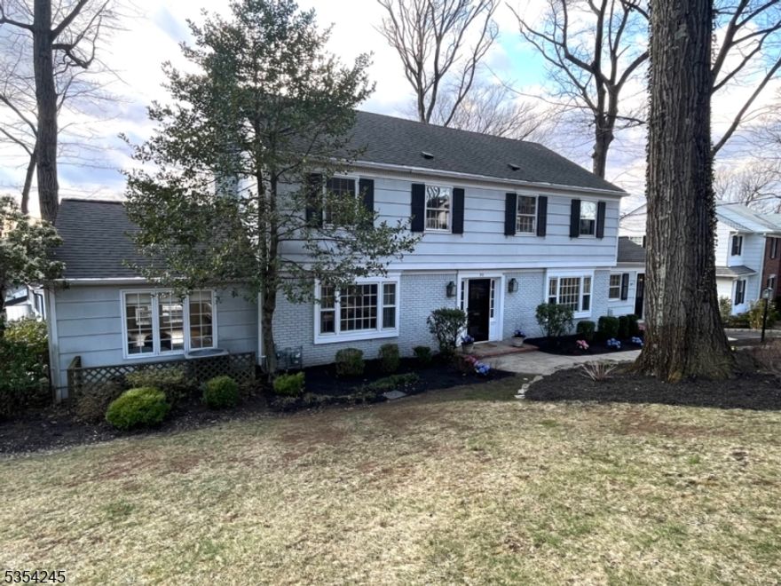 Spacious center hall colonial with lots of light and easy flow for everyday living and entertaining. Double sided wood burning fireplace in the living room and family room. Family room has vaulted ceiling and access to deck and patio. Four bedrooms and two baths on second floor. Whole house generator. Finished walkout basement.
