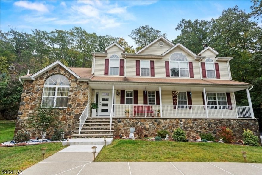 Nestled in the highly sought-after Olde Milford Estates, this beautifully maintained Colonial-style home sits on a serene wooded lot and offers exceptional space and versatility with 5 bedrooms and 2.5 bathrooms. A tasteful blend of marble, laminate, and hardwood flooring creates a warm yet elegant ambiance throughout.The first level features an inviting entrance vestibule and a well-designed layout that includes a sun-filled living room with a wood-burning fireplace, a formal dining room, a spacious gathering room, a full main bath, and a first-floor bedroom, ideal for guests, a home office, or flexible living. The eat-in kitchen is equipped with a center island, ample cabinetry, and direct access to the deck, perfect for entertaining or everyday enjoyment.Upstairs, the second level offers four generously sized bedrooms and additional baths. The primary suite serves as a private retreat with a walk-in closet and an ensuite bath featuring a jetted tub and separate stall shower.The walkout basement provides valuable bonus space with a den, game room, workshop, and storage. Additional highlights include a two-car attached garage, wide driveway parking, and a deck overlooking the tranquil wooded surroundings. Close proximity to multiple lakes, hiking trails, ski resorts, wineries, and so much more, this classic Colonial combines timeless charm, functional living, and a premier location in Olde Milford Estates.