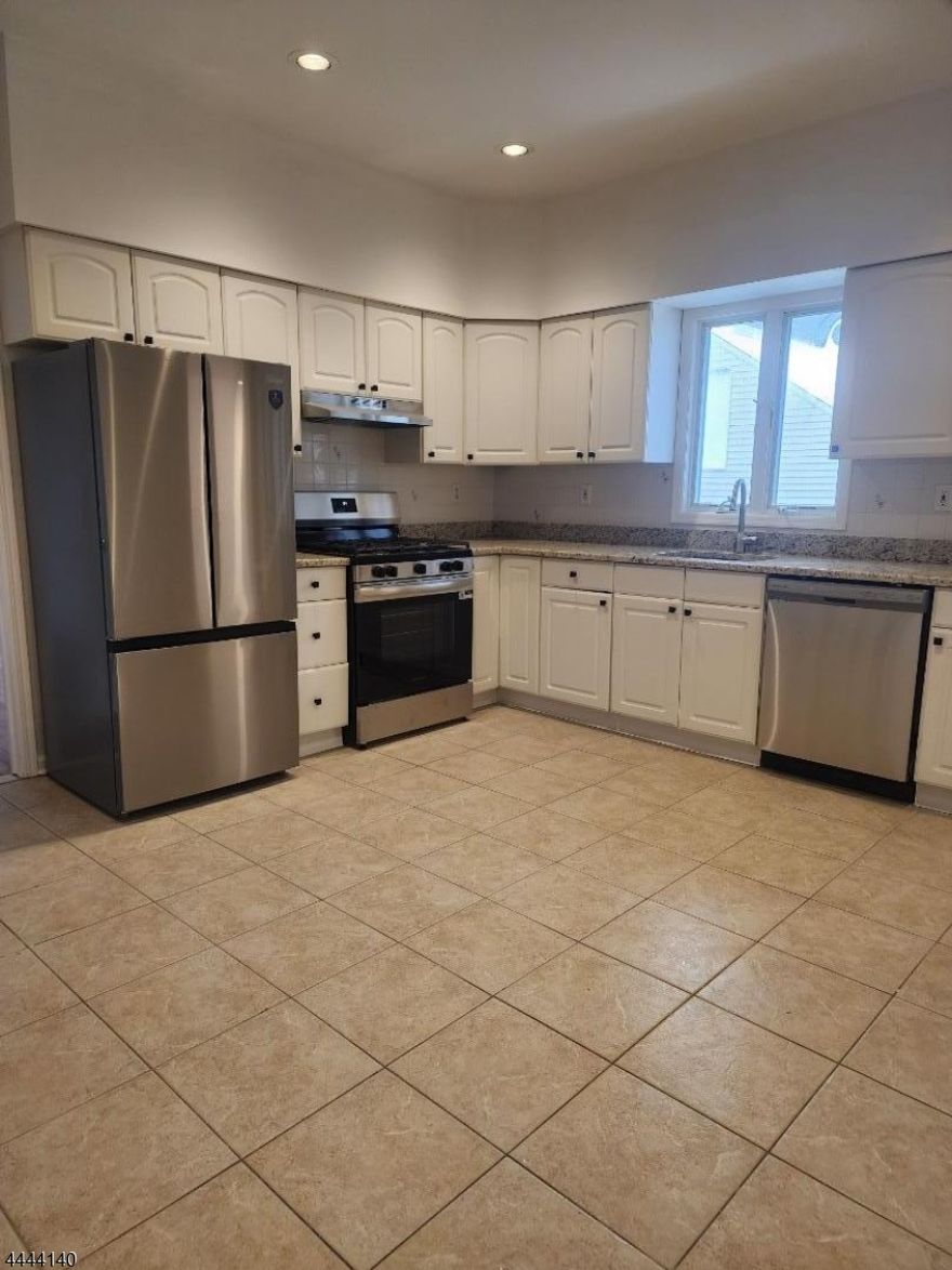 FABULOUS First Floor apartment!  Front and back entrance.  Beautiful hardwood floors, large eat in kitchen with large pantry/storage and washer/dryer.Great size liing room and two large bedrooms with a Bonus room can be used as an office.  GREAT SPACE.   Freshly painted, new appliances, new counter tops, new lighting, new bathroom vanity, resurfaced tub, etc.. One side of the two car garage for tenant's use. Use of backyard.