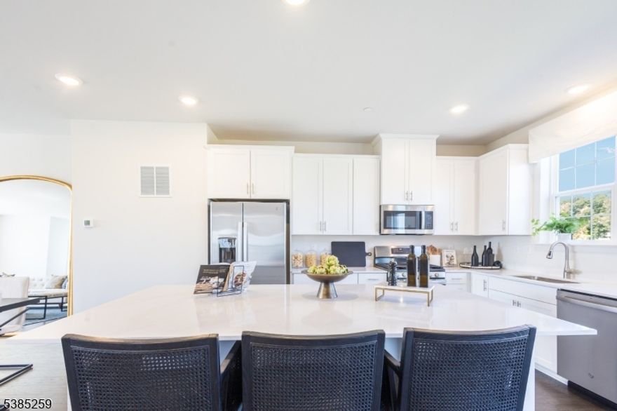 Amazing opportunity at our beautiful community Valley View Park in East Hanover NJ! This Pershing Townhome located in prestigious Morris County and features a 2-car garage and bonus room that leads you to a private outdoor space. Open concept main living space with an abundance of windows and sliding door to your own 2nd story deck.   Totaling 3 bedrooms and 2.5 baths this Pershing includes over 2400 sf of living space!  9ft ceilings & wall to wall hardwood floors on the main living level. Entertain in this spectacular kitchen w/ Silestone quartz countertops & center island, shaker style cabinets, & stainless appliances. Enjoy function & flow in your owner's suite with a spacious walk-in closet, ensuite with double vanity & quartz countertop. The hall bath includes a double vanity sink as well for the two additional bedrooms! A dream location only minutes away from local shopping, great dining. Accessible to rt. 10 & 287 and close to NYC transportation.