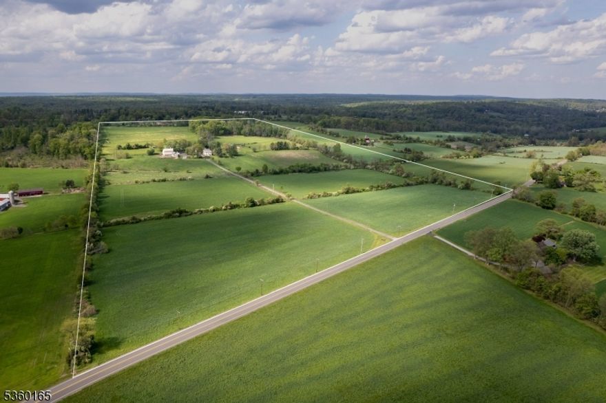 89 acres roll out like a pastoral dream - this is not your average farmstead. This is a place where traditions are honored, animals are well-housed, and there's a proper barn just for parties complete with a barrel-vaulted ceiling and a bar. Featuring fenced paddocks, dry lots, and barns that still serve their original purpose: 4 stall horse barn with heated tack room, a hayloft that swallows up to 1,200 bales, dairy barn brimming with potential, and a proper chicken coop. At the center, the 19th-century farmhouse has been added upon and transformed - warmed by two grand gas fireplaces. The kitchen, with its oversized island, hearth, and casual dining nook, is where the hours melt away. The great room, with its soaring ceiling and shuttered interior windows, is equal parts music hall and quiet escape. The living room spills out onto a wide bluestone patio. The dining room still knows how to host a holiday, and the upstairs main bedroom is thoughtfully tucked away from the others, one of which hides a cedar closet. There's laundry upstairs, a sauna below, and a stone-walled nook that all but begs to become a wine cellar. Elsewhere on the property are surprises that stretch this estate beyond a single narrative: a garage with a finished game room above, a storybook cottage-style apartment, another two-bedroom apartment with a loft, and a studio with its own bathroom. In a world that moves too fast, this is a place that knows how to slow down while keeping farm life humming.