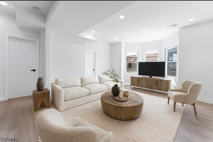 Welcome to 437 Bramhall Avenue; a beautifully renovated four-family Victorian gem sitting on an oversized double lot in Jersey City's sought after Bergen Lafayette neighborhood. Just a 4-minute walk to the Light Rail with direct access to NYC, and located directly across from the lush expanse of Berry Lane Park, this is your chance to own a high performing investment property with unbeatable convenience, skyline views, parking and a yard! With a cap rate of 6.78% and a net operating income of $113,208, this turnkey property is perfect for both savvy investors and owner-occupants seeking additional income. Each unit has been thoughtfully updated and is move-in ready no renovations needed. Live in one and rent out the others, or lease all four for maximum returns. Unit 1 (Garden Level): 2 beds, 1 bath with dual front and rear entries, a charming kitchen, sunny living area with large windows, and central air. Walk-out access to a side yard makes this a standout. Unit 2 (2nd Floor): Spacious 2 beds, 1 bath with large rooms, an eat-in kitchen, and private deck access through the back. Unit 3 (3rd Floor): A full-floor 3-bed, 2-bath residence offering NYC skyline views, a large living area, and stylish finishes. Unit 4 (Top Floor): A bright and airy 1-bedroom, 1-bath, approximately 800 sqft, with spectacular NYC views from the living room, bedroom, and bath.