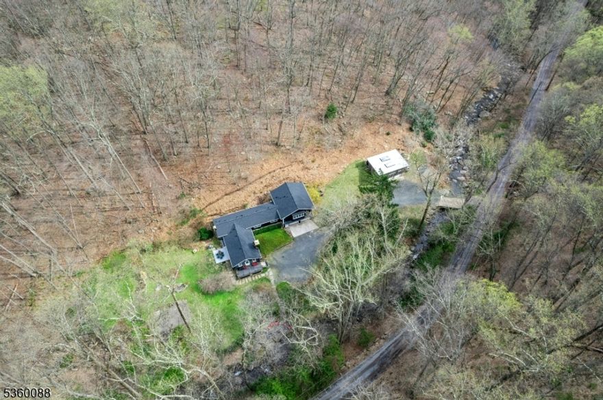 Just an hour from NYC, immerse yourself in the tranquil beauty of this stunning weekend retreat. Set on a picturesque 9.5-acre estate, this exquisite property is a haven for both nature lovers and creative minds, featuring a versatile artistic studio space, well established gardens, and an outside living space with hardi-plank porch and patio as well as a streamside slate patio.The renovated home boasts 2 bedrooms and 4 luxurious full baths. A unique wing of the house can easily transform into an in-law suite or guest quarters. The kitchens are a culinary dream, equipped with high-end appliances including Sub-Zero refrigerator, Bosch oven, and a Wolfe stove, making it perfect for entertaining.The open floor plan, highlighted by sleek, modern design elements, creates an airy and inviting atmosphere. Updates such as a new roof, freshly painted exterior, Anderson windows, and meticulously maintained buildings ensure you can move in with peace of mind. Plus, a full-house generator and a comprehensive home warranty plan provide added security.This exceptional property offers a perfect blend of luxury, comfort, and tranquility. Don't miss the opportunity to own this slice of paradise schedule your visit today and experience a true escape!