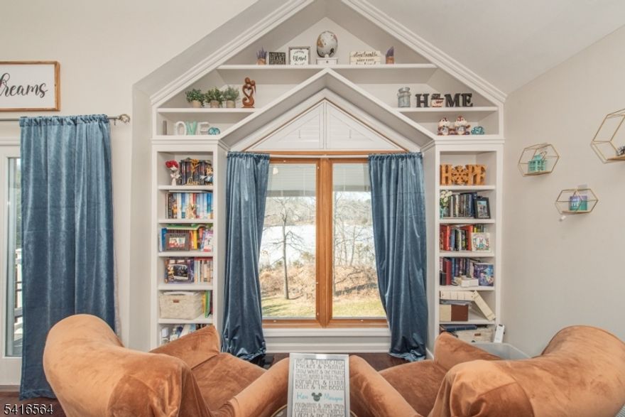 Welcome to your new lakefront home!As you arrive, you'll immediately notice the ample parking in front of the home, convenient for homeowners & guests.Step onto the new Trex front porch, & enter where you will be greeted with the lots of natural light & an open modern layout which flows seamlessly through the main living areas.A generous size bedroom & office is conveniently located on the main level. The updated kitchen is equipped with new appliances & a built-in Miele coffee maker, making it the perfect place to start your mornings.Sliding doors off of the kitchen lead out to the deck overlooking the lake, where you can enjoy meals with breathtaking sunsets over the water.Head upstairs to 3 additional bedrooms & the main bath.The spacious and impressive primary bedroom boasts high vaulted ceilings, a sitting area, en suite, & absolutely stunning lake views.This home also features a fully finished basement, providing extra living space that can be used as a recreation room, media area, gym, or playroom.Step outside to enjoy the flat backyard that leads directly to the water and a new dock, perfect for swimming, kayaking, fishing, or simply enjoying the tranquil lake setting.The backyard is a true oasis, offering a large, quiet, and peaceful space perfect for relaxing or entertaining. Additional major updates include two newer AC units, a newer furnace, and a newer roof, giving you peace of mind for years to come!A rare opportunity for an updated & move-in ready lakefront!