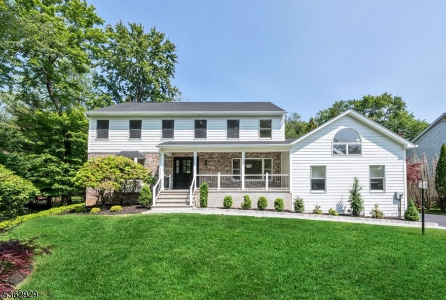 This beautifully renovated home offers light-filled interiors, neutral finishes & exceptional curb appeal with new Hardiplank siding & a welcoming covered front porch. Located in a picturesque neighborhood with private wooded views, the backyard is a true retreat complete with a large deck, patio & sparkling pool. The spacious 1st floor boasts a formal living room with French doors, large dining room & a stunning new kitchen with a large center island, high end appliances, beverage station and sliders to the deck. Open floor plan to the bright family room with gas fireplace & wall of windows overlooking the backyard. A mudroom, powder room, laundry room & access to the 5th bedroom or bonus room adds convenience & flexibility. Upstairs, the primary suite includes a luxurious bathroom with vaulted ceiling, skylights & soaking tub with serene yard views. An additional ensuite, 2 more spacious bedrooms & a hall bath complete the level. The fully finished basement includes a large rec room, office/gym, full bath & potential 6th bedroom with its own garage access.  This home is one you won't want to miss.