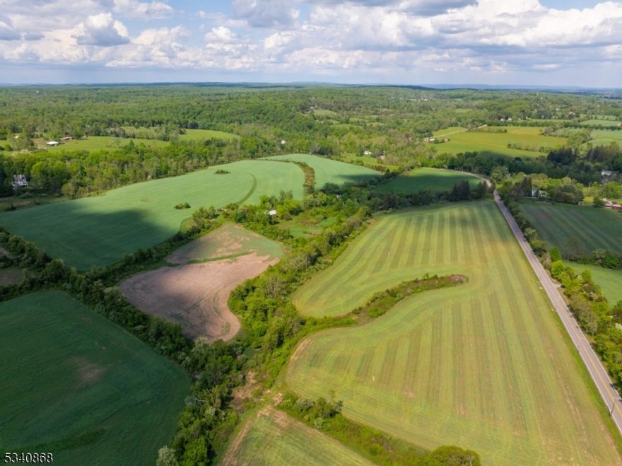 Charming 92+ Acre Farmstead with Endless Possibilities in Hunterdon County! Nestled in the rolling countryside of Hunterdon County and the picturesque Storybook Valley, this breathtaking 92+ acre farmstead offers a rare opportunity to own a piece of history while crafting your dream home. With a protective easement ensuring the land's beauty remains untouched, the property allows for one new home of any size, while also offering the flexibility to improve the existing residence or live in it while building. The original 3 bedroom, 1.5 bath, stone farmhouse exudes character, featuring a large stone fireplace in the kitchen a cozy focal point perfect for gathering and one of the largest in Delaware Township. The property also boasts four barns, ideal for equestrian pursuits, farming, or hobbyist needs. An in-ground pool provides a serene retreat, making this estate a perfect blend of rustic charm and modern luxury. A fieldstone spring house also sits on the property with fresh running water coming up from the ground and entering a stream. Located just down the road from the iconic Green Sergeant Covered Bridge, this one-of-a-kind farm offers a picturesque setting with unparalleled privacy, yet remains conveniently close to local amenities. Whether you envision a grand estate, a working farm, or a tranquil countryside escape, this exceptional property is ready to fulfill your vision. Don't miss this once-in-a-lifetime opportunity! Schedule your private tour today.