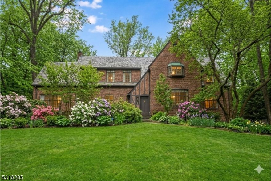 This is your chance to rent a stately Tudor-meets-Colonial masterpiece! Set back on nearly 3/4 of an acre along one of the town's most prestigious streets, this home seamlessly blends timeless elegance with modern comfort. From the moment you enter, you'll be enchanted by grand-scale rooms, soaring ceilings, and exquisite architectural details that exude sophistication and charm. Honey-stained hardwood floors flow throughout, adding warmth and character.  At the heart of the home is an expansive eat-in kitchen a chef's dream with top-tier Viking and GE Monogram appliances, sleek granite countertops, and stainless steel finishes. Adjacent to the kitchen is a spacious 4th bedroom or office, offering flexibility to suit your needs. The inviting main level also features a sunlit solarium leading to a cozy three-season room, a private office, an updated powder room, and open, airy living spaces filled with natural light.  Step outside to a beautifully landscaped backyard oasis, complete with a stunning brick patio ideal for entertaining or relaxing. Upstairs, you'll find an ensuite primary bedroom and two generously sized additional bedrooms. The finished lower level is an entertainer's dream, boasting a full wet bar, recreational room, laundry area, and abundant storage.  Moments from town, the jitney (just outside the home), train to NYC-.7 Miles, shops, restaurants, and houses of worship, this home offers unparalleled convenience while nestled in a serene, prestigious setting.