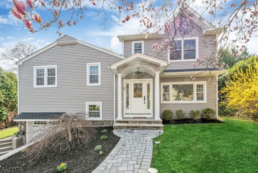 Welcome to this beautiful and fully renovated home, where thoughtful design meets everyday functionality. Nestled in a quiet setting, this home offers the perfect blend of open-concept living and a quiet retreat, all within minutes of schools, parks, and easy NYC transportation. The main level boasts a light-filled living room and a gourmet eat-in kitchen featuring a large center island, sleek quartz countertops and stainless-steel appliances. The open dining area flows through into a charming three-season porch, perfect for enjoying the private backyard. Just a few steps down, the finished lower level offers a family room, convenient powder room and a functional mudroom with custom built-ins. Nearby oversized garage with abundant storage space. The 2nd level features 3 spacious bedrooms and a renovated hall bath, while the 3rd floor serves as a primary retreat with soaring vaulted ceilings, 2 custom walk-in closets, an ensuite bath with double vanities and a separate laundry room. This is one you will want to call home. Nothing to do but unpack!