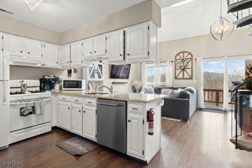 Walk right in to this move-in-ready 2-bedroom, 2-bathroom condo located in the heart of Great Gorge Village. Featuring a functional kitchen equipped with granite countertops, standard appliances, and a breakfast bar that opens directly to the main living area. The interior is highlighted by impressive lofted ceilings, creating a sense of volume and space rarely found at this price point. With two full bedrooms and two full bathrooms, the layout is perfectly suited for a primary residence, a vacation getaway, or an investment property. Step outside to your private deck to enjoy unobstructed sunset views overlooking the golf course. The location offers unparalleled access to Vernon?s premier attractions; you are just minutes from Mountain Creek Ski Area, Crystal Springs Golf Resort, and the Minerals Sports Club.