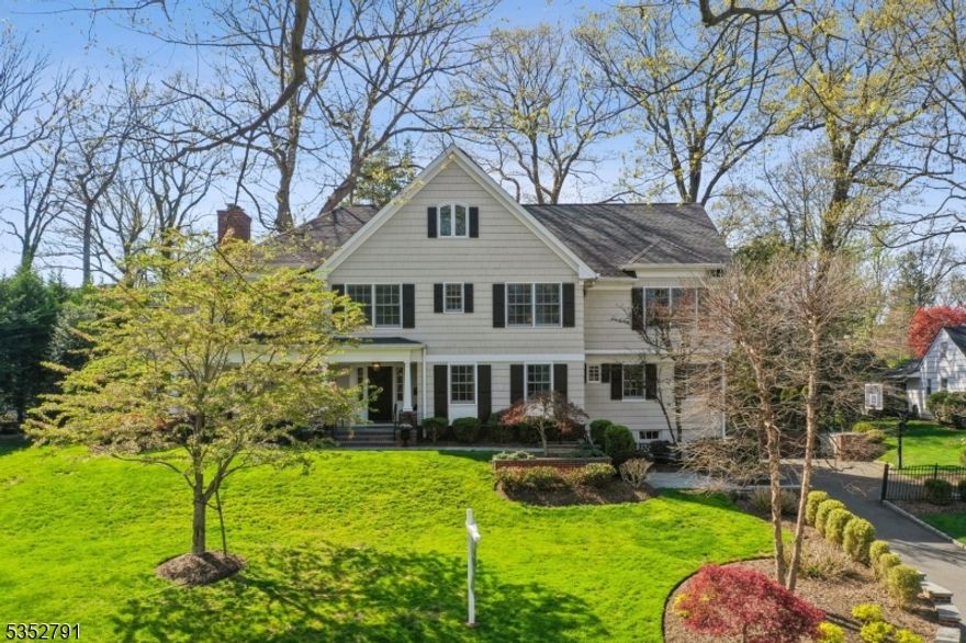 This Stunning Classic Colonial on sought-after Oak Ridge Avenue in Summit, NJ, offers the perfect blend of timeless charm and modern living. Featuring 6 bedrooms, 4 full and 2 half baths, this beautifully maintained home welcomes you with a flowering front walk and a charming covered porch. The spacious foyer opens to a private office and a sun-filled living room with a cozy sunroom. The heart of the home is the open-concept kitchen and family room, offering seamless flow and views of the private, flat, manicured backyard, complete with a fabulous patio and an adorable playhouse. A formal dining room off the kitchen completes the first floor's elegant layout ideal for entertaining or relaxing. Upstairs, the expansive primary suite features a tray ceiling, an oversized walk-in closet/dressing room, and a luxurious bath with a steam shower and soaking tub. Four additional bedrooms finish the second level, including one with an en-suite bath, plus a large hall bathroom and a convenient laundry room. The third floor includes a sixth bedroom with an en-suite bath, a spacious recreation room, and additional storage. A large basement features a mudroom and half bath directly off the 2 car garage, as well as a recreation room and gym. This exceptional home truly has it all; classic beauty, a thoughtful layout, top-rated schools, and an unbeatable location close to Summit's vibrant downtown, with shops, restaurants, and direct trains to NYC.