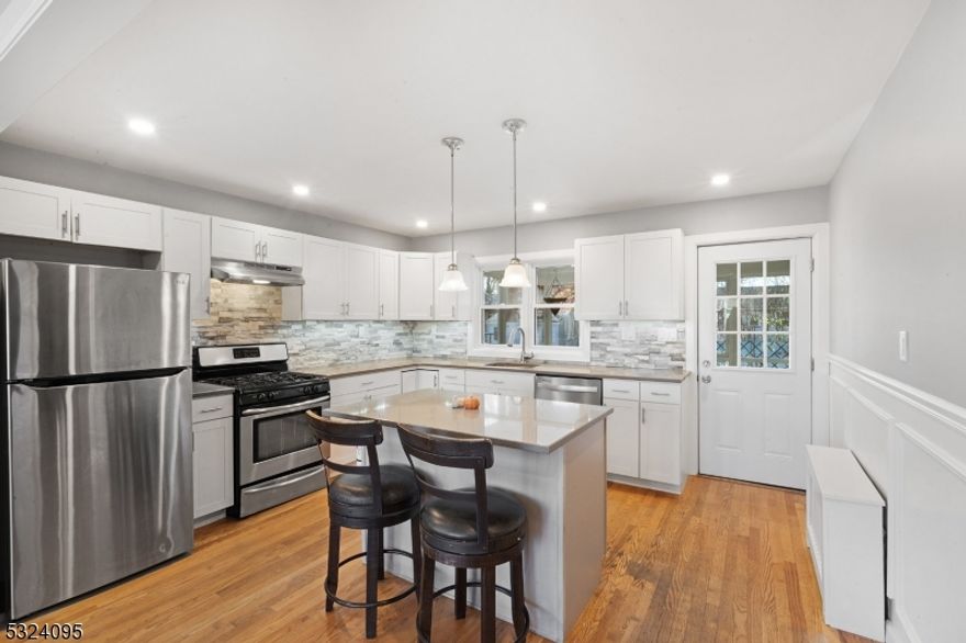 This beautifully updated 4-bedroom, 2-bathroom Cape Cod in Colonia seamlessly combines comfort with convenience. Step inside through the upgraded front door to find a bright, elegant living room adorned w/stylish picture molding. The open layout to the modern kitchen is a chef's delight, featuring stainless steel appliances, sleek white shaker cabinets, & a stunning stone backsplash adds sophistication. A central island provides prep space, perfect for cooking & casual gatherings. Direct access to the backyard through a glass-panel door leads to a charming 3-seasons room, extending out to a patio & fenced-in yard, complete w/new shed for storage (2019). Inside, warm hardwood floors span the 1st & 2nd levels throughout the home.The first-floor bath boasts modern design. 2 spacious bedrooms complete the main level, while upstairs, 2 additional large bedrooms offer ample closet & storage space. Primary bedroom includes a second, updated full bath.The finished basement provides a versatile space that can be customized to fit your lifestyle needs, whether as a home theater, game room, or gym. A/C added in 2021; 2 units - bsmt & 1st floor (potential for 3 more units).  Fresh, neutral paint & durable wood-look flooring, this space combines style w/functionality. Conveniently located near major highways & NJ Transit, commuting to NYC is effortless, 7 local shopping centers, parks, and community pool (Clark) are all within reach. This move-in-ready, renovated Cape is waiting for you!