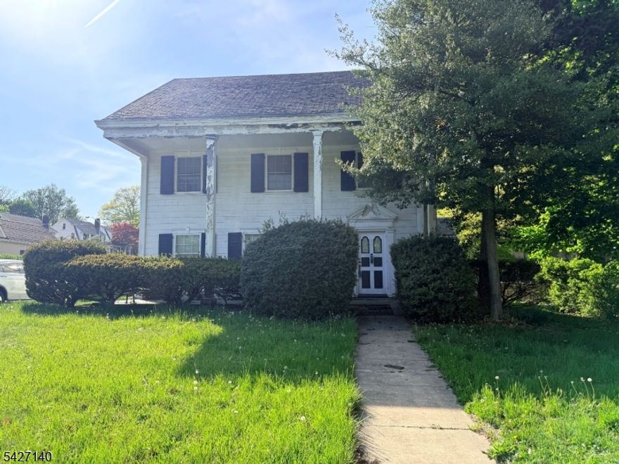 True sweat equity opportunity in the sought-after Seven Oaks section of Orange. Bring your vision, tools, and renovation financing options, including 203(k), to transform this spacious property into its full potential. This home offers generously sized rooms throughout, featuring hardwood floors across all levels. The first floor includes a living room with fireplace, a formal dining room, and a large eat-in kitchen. The second level provides three well-sized bedrooms, while the third level expands the living space with an additional bedroom, loft area ideal for a home office or flex space, a full bath, and a walk-in attic for storage. A large unfinished basement offers additional potential for customization and includes a newer gas furnace and hot water heater (approximately 5 years old). Additional features include an attached one-car garage, patio space, ample closet storage, and an extended driveway accommodating multiple vehicles. Located across from Monte Irvin Park, offering nearby outdoor space and recreation. Property requires updates and is being sold strictly as-is. Buyer is responsible for obtaining the Certificate of Occupancy and completing all municipal inspections and required repairs.