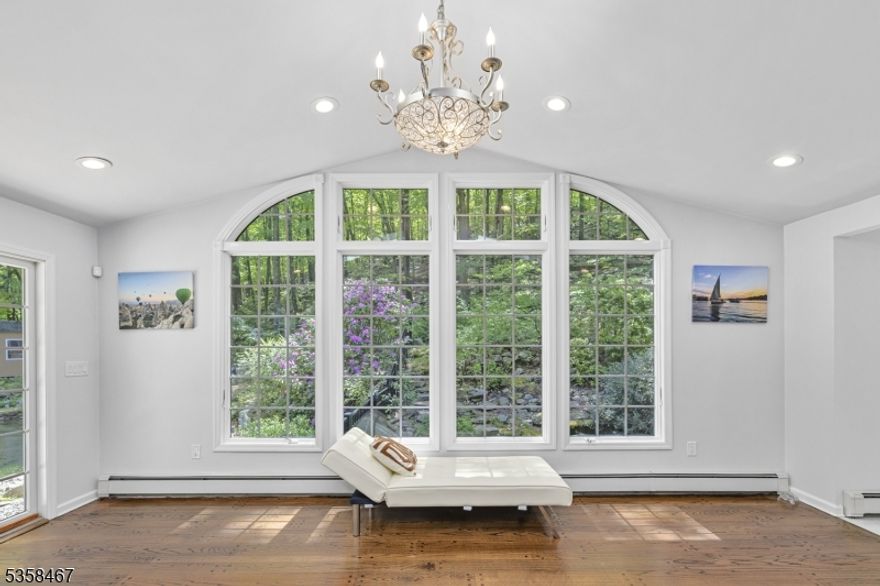 Set on over 3 secluded, tree-lined acres, this private oasis blends natural beauty, tranquility, and convenience just minutes from downtown Morristown, the Midtown Direct train to NYC, and nearby parks and trails. Nestled far from the road and surrounded by mature landscaping, the home greets you with serene gardens, a koi pond with a cascading waterfall, and a stone patio ideal for outdoor entertaining or quiet evenings. Inside, enjoy panoramic views and sunlight from every room. The vaulted family room features a striking wall of windows overlooking the pond and lush surroundings. The open kitchen with granite countertops flows into a bright breakfast nook perfect for morning coffee. A first-floor office or guest bedroom offers flexibility for today's lifestyle .Upstairs, the luxurious primary suite includes a spacious sitting/dressing room with a full wall of closets, a marble bath, and a Jacuzzi tub creating a spa-like escape. Additional bedrooms are generously sized, full of natural light, and share a newly renovated hall bathroom. The finished basement expands the living space with a large rec room, ideal for a playroom, gym, or media center. Whether you're looking for peaceful solitude or space to entertain, this home offers the best of both worlds nature, comfort, and accessibility. This home is located in Mendham Township but has a Morristown mailing address.