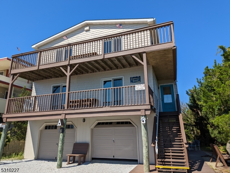 Beach lover's dream! Enjoy stunning, unobstructed views of Barnegat Lighthouse, Inlet and natural beauty without leaving your home! Nestled in the dunes, and a short hike to the light house, jetty and State Park with beach taxi access in season.  Walking distace from restaurants and local shops. 2 car garage is located under the house on ground level. Ascend the stairs to 1st level where you will find 3 bedrooms and additional 4th room for office, den or bedroom space. Laundry room with 1/2 bath and additional full bath also on the 1st level of the home.  Second level is comprised of an open concept kitchen and family room with 1/2  bath and primary bedroom with full bath. Climb to the 3rd floor rooftop deck and stargaze, catch the sunrise or beach watch from this exclusive and secluded LBI get-a-way. All appliances included,  Income potential as a rental property. House being sold "as is".