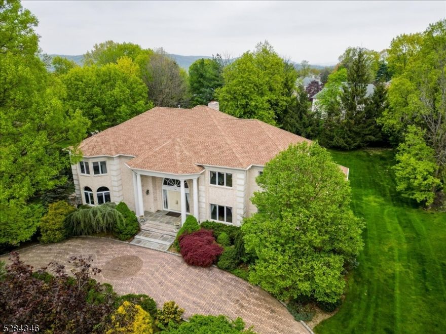 Custom colonial in the prestigious High Ridge Estates combines luxury living w/ detailed craftsmanship. Enter through the grand 2 story foyer, you are greeted by an elegant marble FL & custom moldings. Spectacular great RM, features cathedral coffered ceilings & a dramatic 2-sided ceiling-to-floor fireplace. This central gathering spot is illuminated by natural light streaming through a floor-to-ceiling transom window, enhancing the home's spacious feel. Adjacent to the great RM, the formal living & dining RM boast a sophisticated ambiance, w/ the dining area accented by a trey ceiling w/ subtle lighting. Spacious office accessible via glass French doors, features arched windows that infuse the space w/ light, creating an ideal environment for both productivity & relaxation. Gourmet eat-in kitchen is equipped w/ a center island, granite counters & pantry. It provides easy access to the Trex deck via sliding doors, perfect for alfresco dining & entertaining. 1st FL also hosts a BR suite complete w/ walk-in closet & full bath, offering privacy & convenience for guests or multi-generational living. Ascending to the 2nd FL, you find 4 BR suites, each w/ their own walk-in closets. The master suite is a true retreat, featuring 3 walk-in closets, dual vanities, jetted tub & stall shower. LL extends the living space w/ a walk-out to a charming paver patio, also incl. full bath, sauna, wet bar & LRG RM that can adapt to multiple uses think home theater, game RM or add'l family RM.