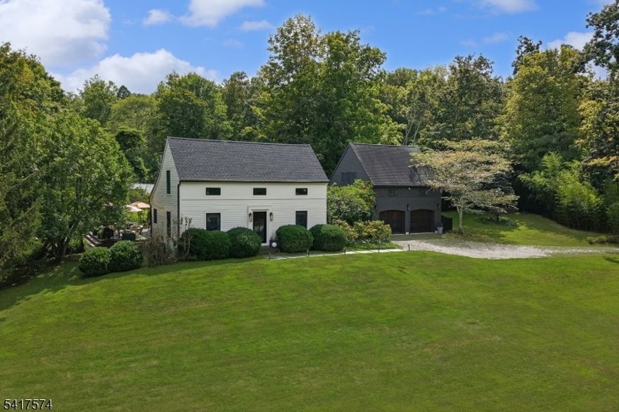 This rare gem of a property is nestled in a striking natural setting in historic hamlet of Mountainville and distinguished by the exceptional attention to aesthetic detail in the extensive renovations undertaken by the current owner. Interior features include open floor plan, plentiful natural light, kitchen with high-end appliances and finishes, solid oak floors, upgraded storage closets and cabinetry, Malm fireplace, and finished and unfinished basement spaces. First floor primary bedroom and multiple spaces suitable for home offices make this home perfect for a range of living arrangements while interior spaces flow to outdoor spaces through oversized glass doors to a large deck linking home to extensive backyard gardens and a striking mountain view. The generously-sized detached garage offers an opportunity for parking/storage/workshop space and features a large, sunny living space above, perfect for use as an artist's studio, home office, gym, or recreation room. System updates include HVAC (2024/2025), new 30-year roof (2024), deck (2024), glass exterior doors. The backyard's stunning secluded gardens feature perennial gardens, winding pathways, accent lighting, and firepit area with privacy and space for entertaining, gardening, or simply daydreaming. The home is accessed by way of a private lane in an exceptional location amidst larger estate and farm properties and easy access to Route 78 making it a remarkable opportunity as a full- or part-time residence.